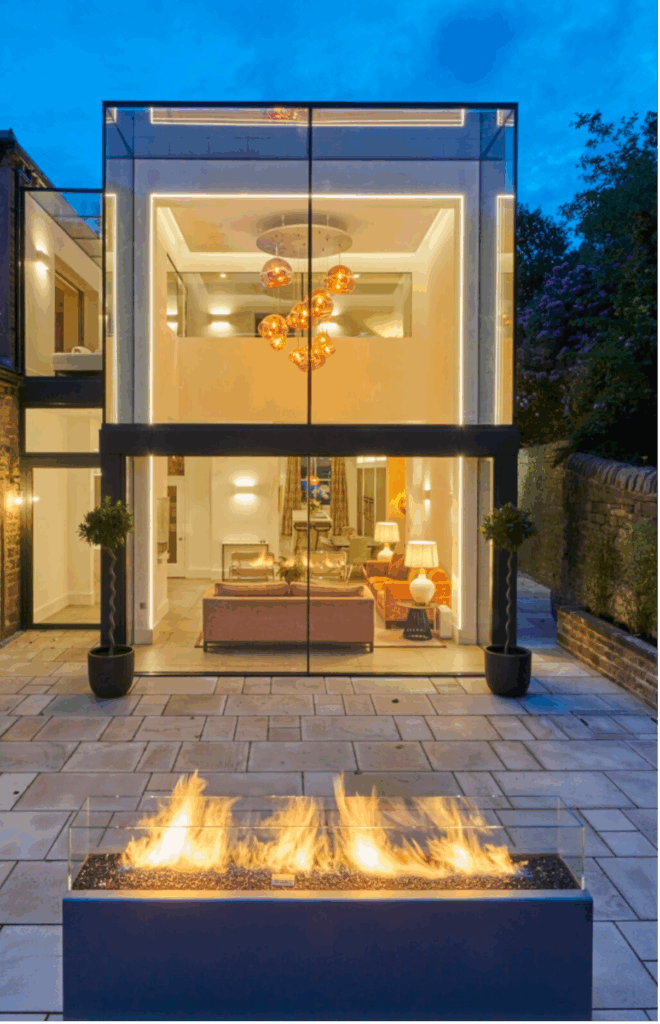 Double-height structural glazing façade with frameless glass walls and roof in London home